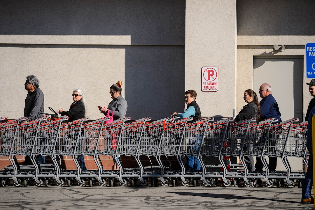 (Trent Nelson  |  The Salt Lake Tribune) Shoppers spaced out in line at the Salt Lake City Costco location on Monday, March 16, 2020.