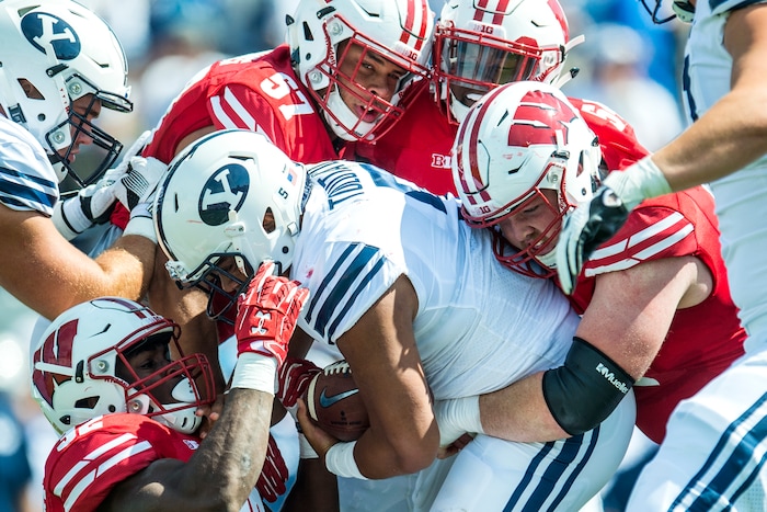(Chris Detrick  |  The Salt Lake Tribune)  Wisconsin Badgers linebacker Leon Jacobs (32) Wisconsin Badgers defensive end Alec James (57) Wisconsin Badgers linebacker Chris Orr (54) and Wisconsin Badgers defensive end Conor Sheehy (94) tackle Brigham Young Cougars running back Ula Tolutau (5) during the game at LaVell Edwards Stadium Saturday Saturday, September 16, 2017. Wisconsin Badgers are leading Brigham Young Cougars 24-6 at halftime.