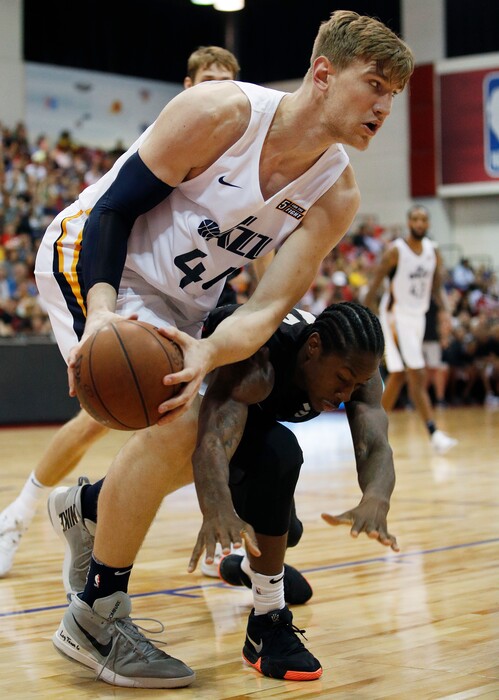 Utah Jazz's Isaac Haas, left, battles for the ball with Portland Trail Blazers' Archie Goodwin during the second half of an NBA summer league basketball game Saturday, July 7, 2018, in Las Vegas. (AP Photo/John Locher)