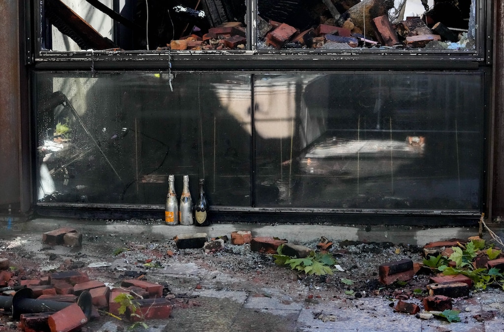 (Francisco Kjolseth | The Salt Lake Tribune) Champagne bottles are pictured in front of London Belle following a fast-moving fire that caused catastrophic damage to it and other businesses on Aug. 11, 2025. 