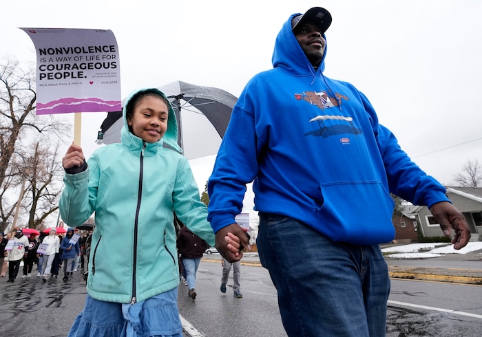 (Leah Hogsten | The Salt Lake Tribune) Jahmal Hasliip and his daughter Jayda, 9, participate in the march from East High School to Kingsbury Hall on Monday. To commemorate the legacy and work of Martin Luther King, Jr. and many other activists fighting for racial equality during the Civil Rights movement, the University of Utah's office of Equity, Diversity & Inclusion kicked off MLK Week 2023 with a rally at East High School, followed by a march to Kingsbury Hall, Jan. 16, 2023. 