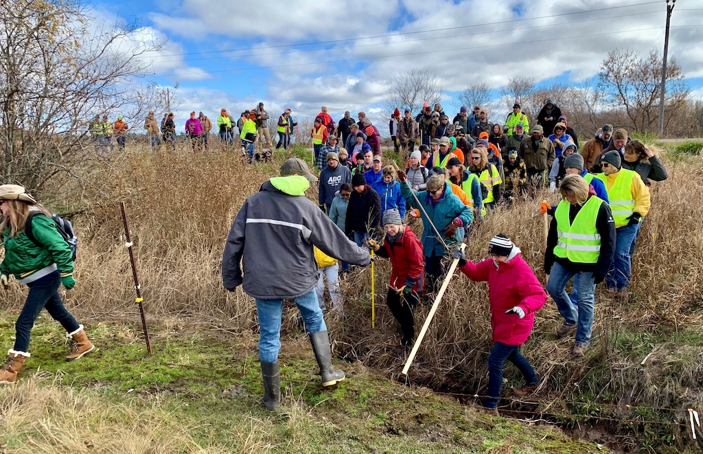 (Jeff Baenen | AP file photo) In this Oct. 23, 2018, file photo, volunteers cross a creek and barbed wire near Barron, Wis., on their way to a ground search for 13-year-old Jayme Closs who was discovered missing Oct. 15 after her parents were found fatally shot at their home. The Barron County Sheriff's Department said on its Facebook page that that the teenager Closs has been located Thursday, Jan. 10, 2019, and that a suspect was taken into custody.