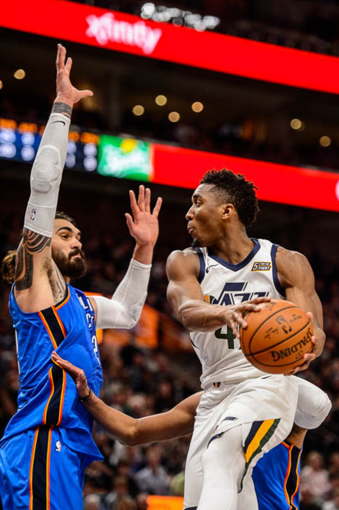 (Trent Nelson | The Salt Lake Tribune)  Utah Jazz guard Donovan Mitchell (45) looks to pass around Oklahoma City Thunder center Steven Adams (12) as the Utah Jazz host the Oklahoma City Thunder, NBA basketball in Salt Lake City, Saturday December 23, 2017.