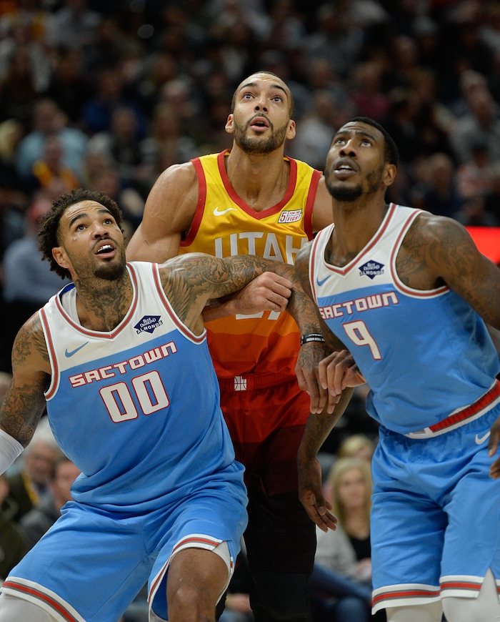 (Francisco Kjolseth  |  The Salt Lake Tribune)  Utah Jazz center Rudy Gobert (27) is defended by Sacramento Kings center Willie Cauley-Stein (00) and Sacramento Kings guard Iman Shumpert (9) during a rebound in the NBA game at Vivint Smart Home Arena Wed., Nov. 21, 2018, in Salt Lake City.