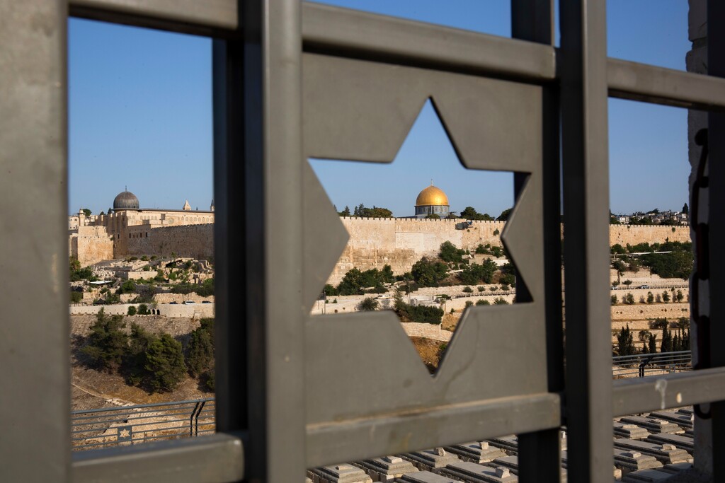 (Oded Balilty | AP)The Islamic Dome of the Rock in Jerusalem's Old City is seen trough a door decorated with a Jewish Star of David in 2017. Columnist Jeffrey Salkin explains how Jewish adherents believe life goes on after death.