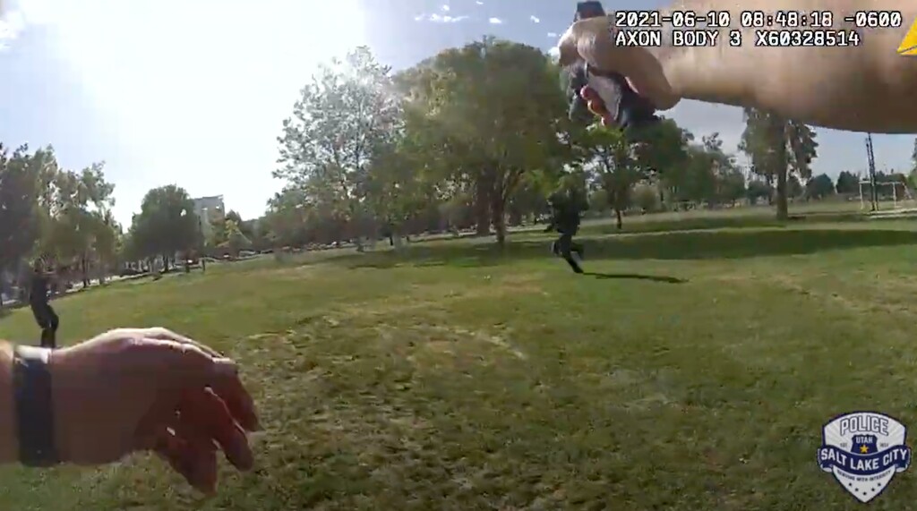 (Salt Lake City Police Department via YouTube) This screenshot shows police shooting at a man armed with a knife in Pioneer Park, Thursday, June 10, 2021.