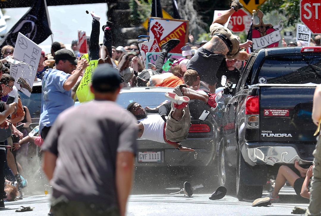(Ryan M. Kelly  |  The Daily Progress via AP)  People fly into the air as a vehicle drives into a group of protesters demonstrating against a white nationalist rally in Charlottesville, Va., Saturday, Aug. 12, 2017. The nationalists were holding the rally to protest plans by the city of Charlottesville to remove a statue of Confederate Gen. Robert E. Lee. There were several hundred protesters marching in a long line when the car drove into a group of them.