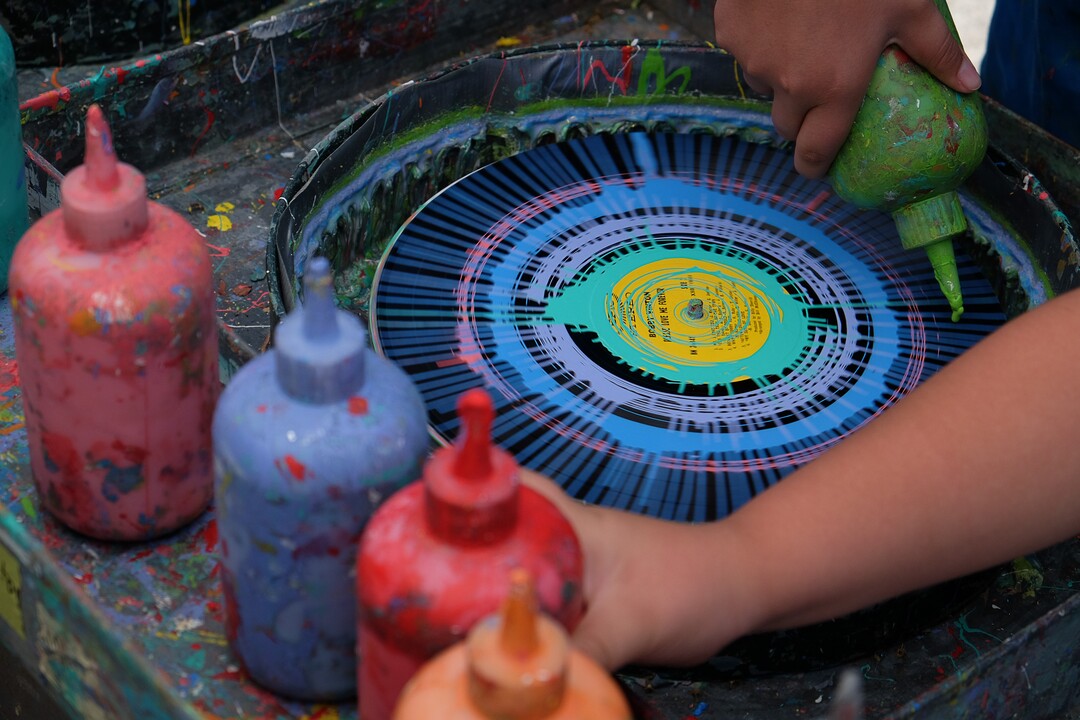(Francisco Kjolseth  |  The Salt Lake Tribune)  Old spinning records powered by bicycle are turned into unique art by young hands at the "Spin Art" booth at the Ogden Arts Festival that brings local and regional artists, creatives and entertainers to Ogden, UT on June 8th and 9th. The Ogden Arts Festival returned to the historic Union Station located in the heart of downtown.