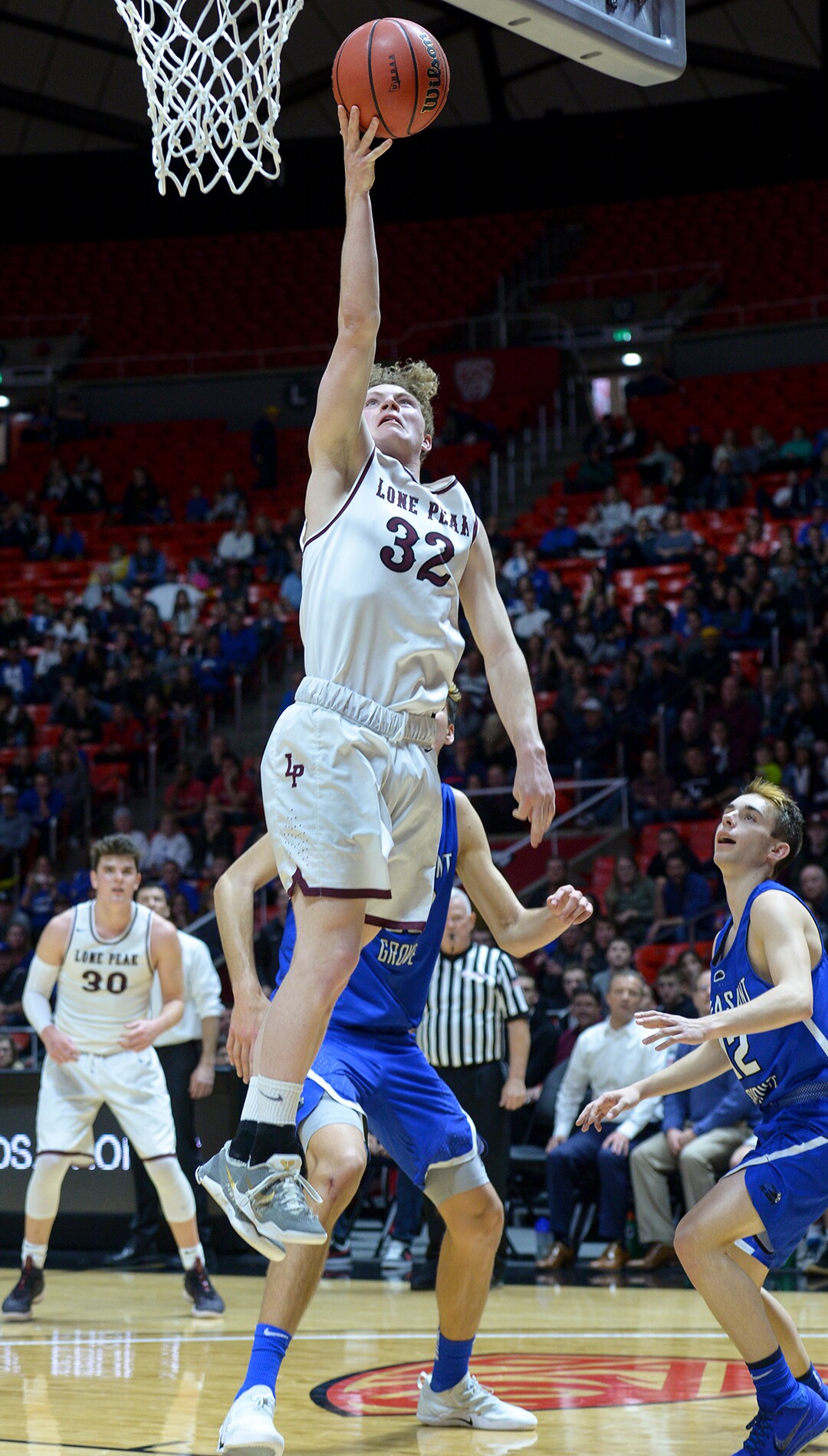 (Leah Hogsten  |  The Salt Lake Tribune) Lone Peak's Taylor Madson (32) drives past Pleasant Grove's Matt Van Komen (22). Lone Peak defeated Pleasant Grove 61-44 to win the 6A High School Boys’ Basketball Tournament Championship at the Jon M. Huntsman Center in Salt Lake City, Saturday, March 3, 2018. 