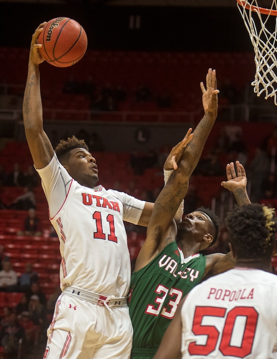 (Rick Egan  |  The Salt Lake Tribune)  Utah Utes forward Chris Seeley (11) dunks the ball over Mississippi Valley State Delta Devils center Jamal Watson (33), in basketball action Utah Utes vs. Mississippi Valley State Delta Devils, at the Jon M. Huntsman Center,  Monday, November 13, 2017.