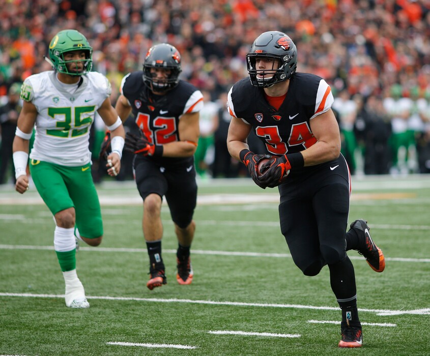 Oregon State's Ryan Nall runs through Oregon's defense in last November's victory for the Beavers in the Civil War rivalry game. (AP Photo/Timothy J. Gonzalez)