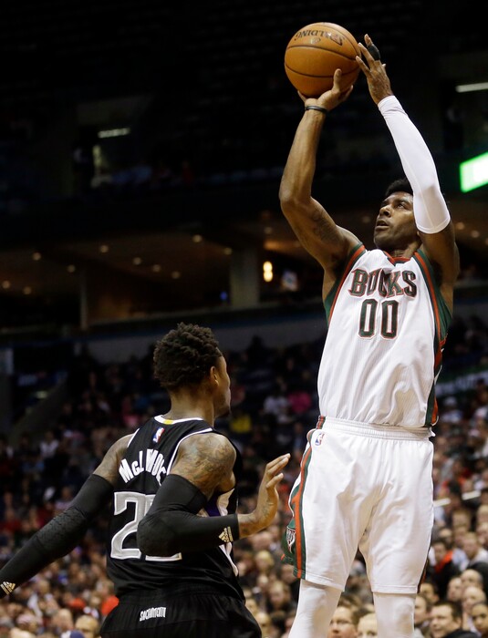 Milwaukee Bucks' O.J. Mayo (00) shoots over Sacramento Kings' Ben McLemore during the second half of an NBA basketball game Wednesday, Feb. 11, 2015, in Milwaukee. (AP Photo/Morry Gash)