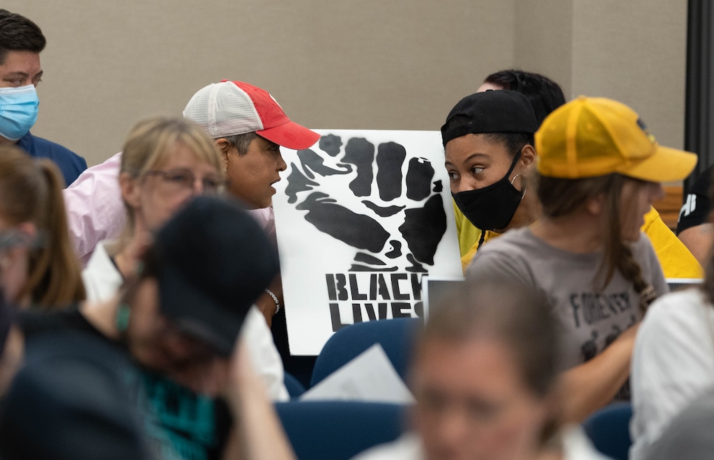 (Francisco Kjolseth | The Salt Lake Tribune) Lex Scott, founder of Black Lives Matter Utah, left, speaks with Rae Duckworth, before she got up to speak in support of critical race theory during a Granite school board of education meeting on Tuesday, July 6, 2021.