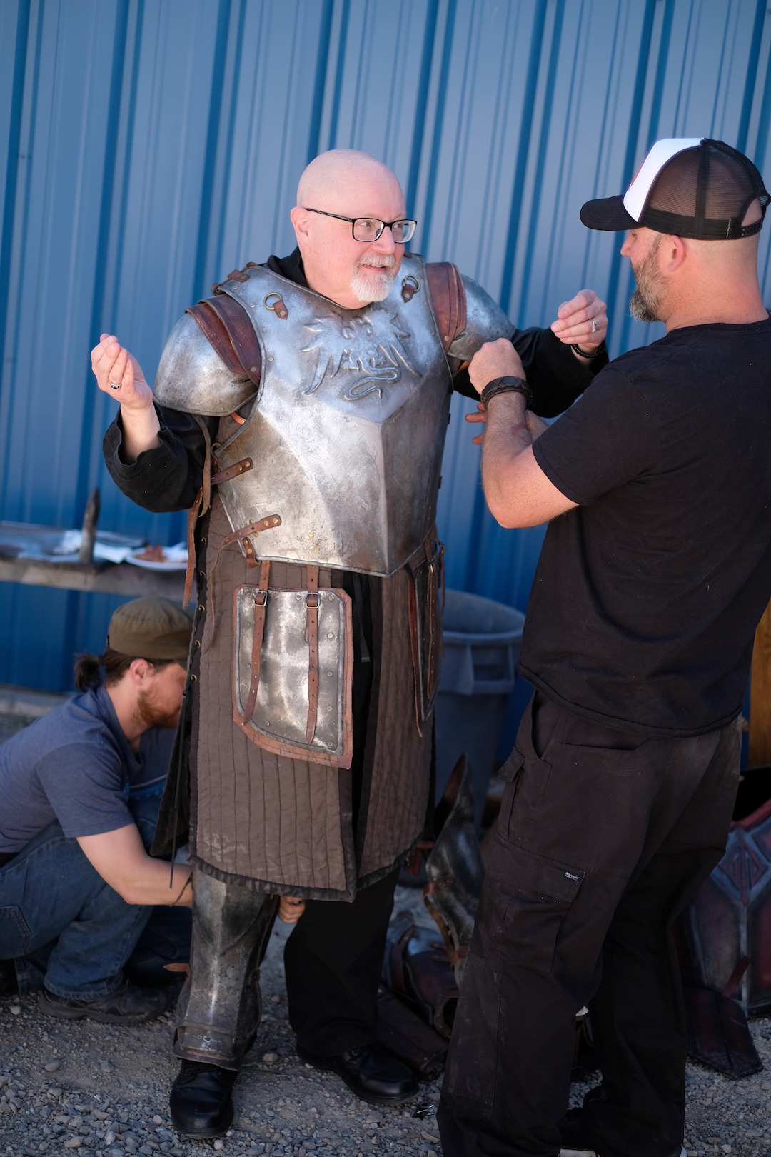 (Photo courtesy Doug Pasko) It takes a team to get Salt Lake Tribune TV critic Scott D. Pierce into a suit of armor on the set of “The Outpost.”