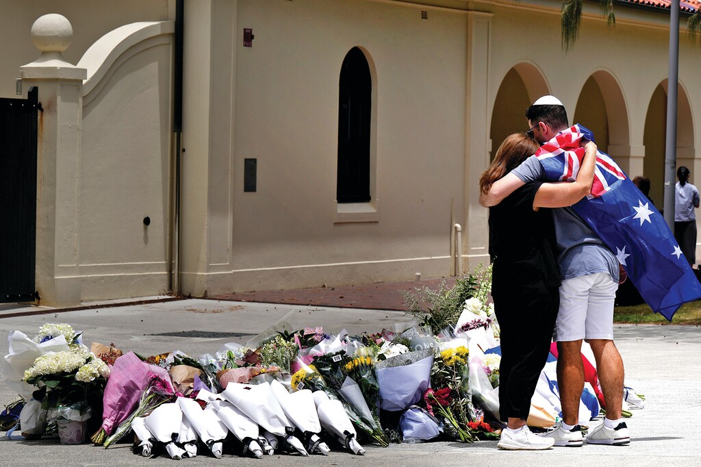Mourners lay flowers at a tribute to shooting victims outside the Bondi Pavilion at Sydney's Bondi Beach, Monday, Dec. 15, 2025, a day after a shooting. (AP Photo/Mark Baker)