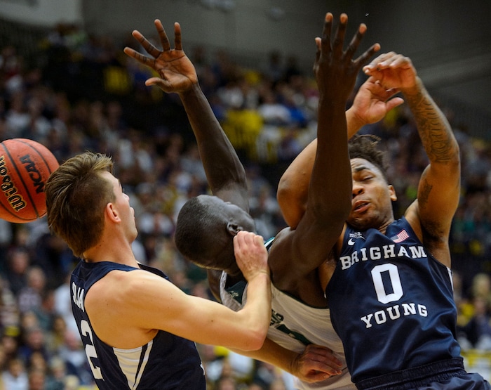 (Steve Griffin  |  The Salt Lake Tribune) Brigham Young Cougars guard Zac Seljaas (2), left, and Brigham Young Cougars guard Jahshire Hardnett (0) crab into Utah Valley Wolverines center Akolda Manyang (0) during the BYU versus UVU basketball game at UCCU Center on the UVU campus in Orem Wednesday November 29, 2017.