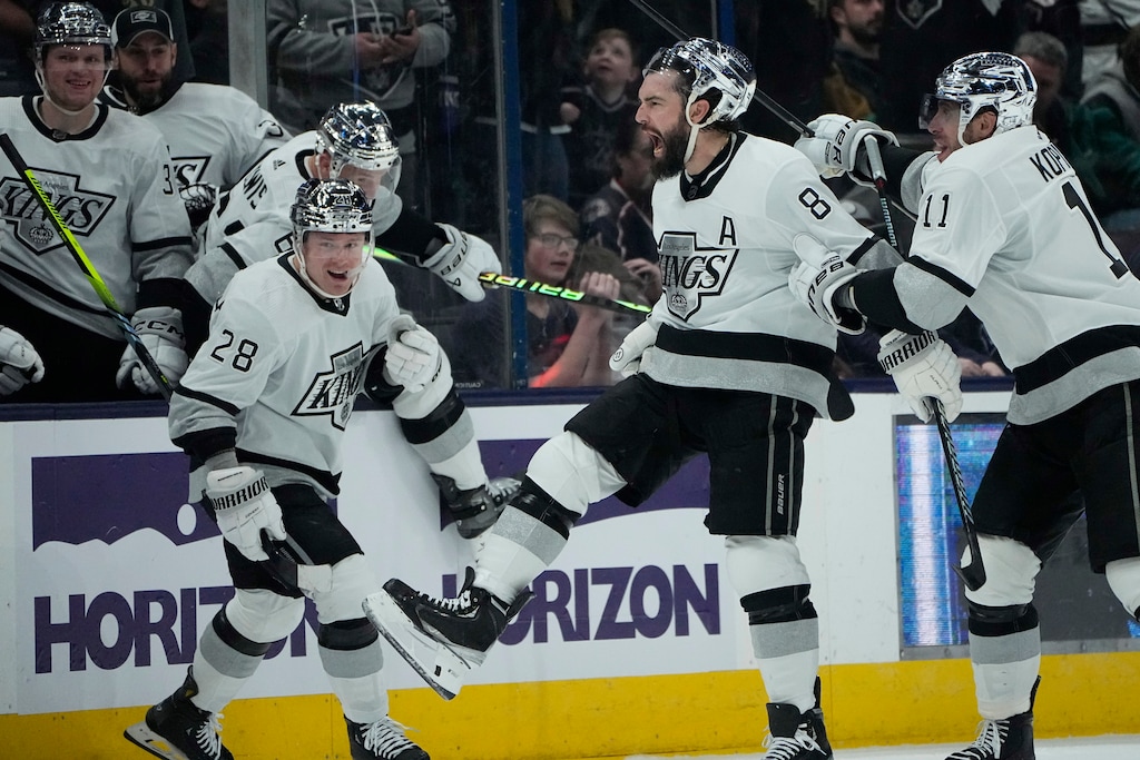 (Sue Ogrocki | AP) Los Angeles Kings' Drew Doughty (8) celebrates his game-winning goal with teammates Jaret Anderson-Dolan (28) and Anze Kopitar (11) in overtime of an NHL hockey game against the Columbus Blue Jackets on Dec. 5, 2023.
