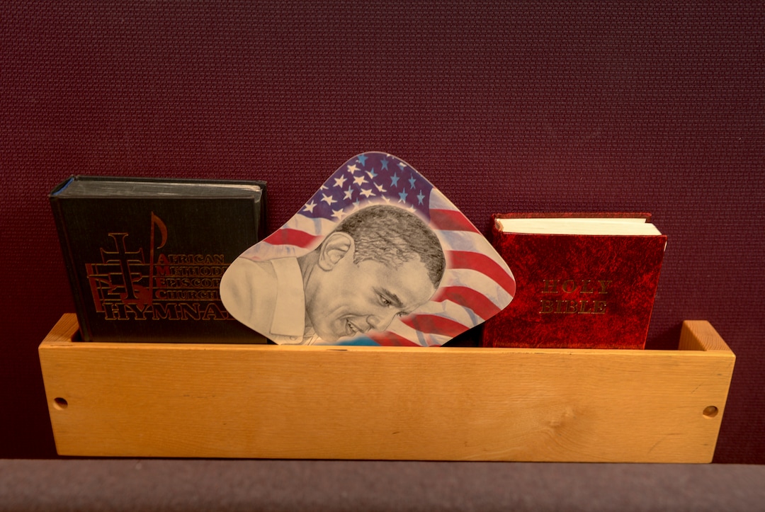 Leah Hogsten  |  The Salt Lake Tribune   A fan with the likeness of President Barak Obama rests between the Bible and the hymnbook rack at the Trinity African Methodist Episcopal (AME) Church, Aug. 14, 2018. The Rev. Nurjhan Govan of the Trinity African Methodist Episcopal (AME) Church is retiring on Aug. 26, 2018.