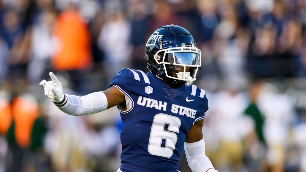 (Tyler Tate | AP) Utah State safety Ike Larsen (6) motions to teammates on defense during on Oct. 7, 2023 in Logan.