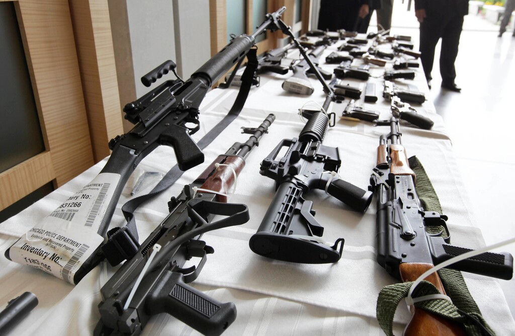 FILE - In this July 22, 2010, file photo, various guns are displayed at the Chicago FBI office. A new poll shows most young adults across racial and ethnic groups support tighter gun polices including background checks, stricter penalties for gun law violations, and banning semi-automatic weapons. In the new GenForward poll, about 9 in 10 young adults say they support criminal background checks for all gun sales, a level of support that remains consistent across racial and ethnic groups.(AP Photo/M. Spencer Green, File)