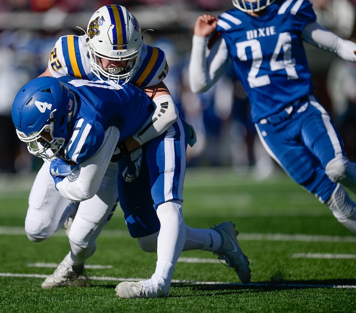 (Francisco Kjolseth  |  The Salt Lake Tribune)  Dixie's Tyson Miller rolls his ankle as receives a pass over Jaxon Williams of Orem in the 4A high school championship game at Rice Eccles Stadium in Salt Lake City, Friday, Nov. 16, 2018.