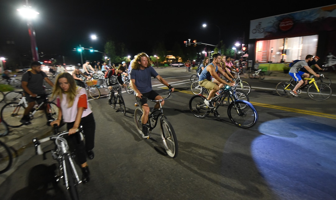 (Francisco Kjolseth  |  The Salt Lake Tribune)  A large group of cyclist begins their ride from the corner of 9th and 9th after gathering after 9pm in Salt Lake City on Thursday, July 26, 2018, for the weekly ride that has become known as the 999 Ride. The inclusive, all-welcoming slow casual social ride happens year round on Thursday nights, with riders often pedaling into the early morning hours. Newly released video shows rider Cameron Hooyer being struck and killed by a FrontRunner train at a downtown railroad crossing during last weeks ride when the 22-year-old failed to stop or heed the warning signals before crossing the tracks during the group ride. 