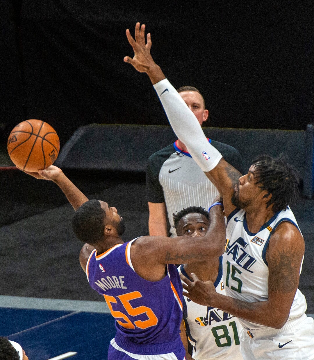 (Rick Egan | The Salt Lake Tribune)  Phoenix Suns guard E'Twaun Moore (55) shoots as Derek Favors (15) defends, in preseason NBA action between Utah Jazz and Phoenix Suns at Vivint SmartHome Area, on Saturday, Dec. 12, 2020.