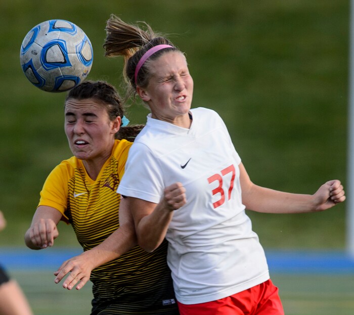 (Steve Griffin | The Salt Lake Tribune) East's Hailey Povilus, right, heads the ball away from Maple Mountain's Julia Dean the 5A semifinal girl's soccer match at Juan Diego High School in Draper Tuesday October 17, 2017.