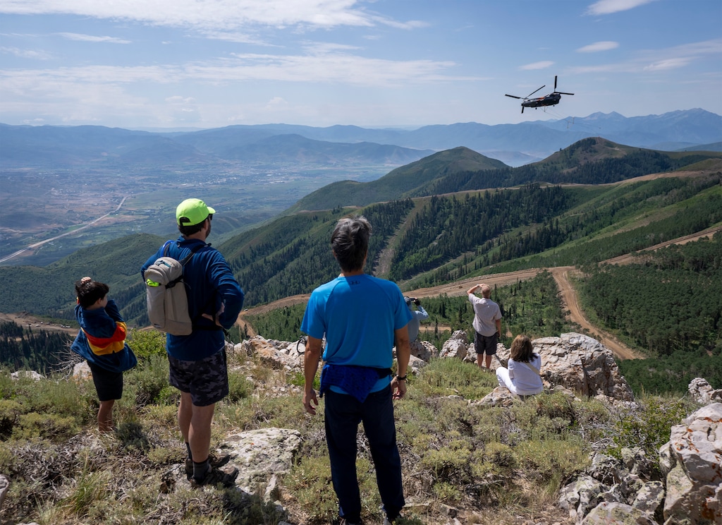 (Rick Egan | The Salt Lake Tribune)  Guests watch as a helicopter hauls a lift tower for the new East Village Express Gondola on Saturday, July 19, 2025.