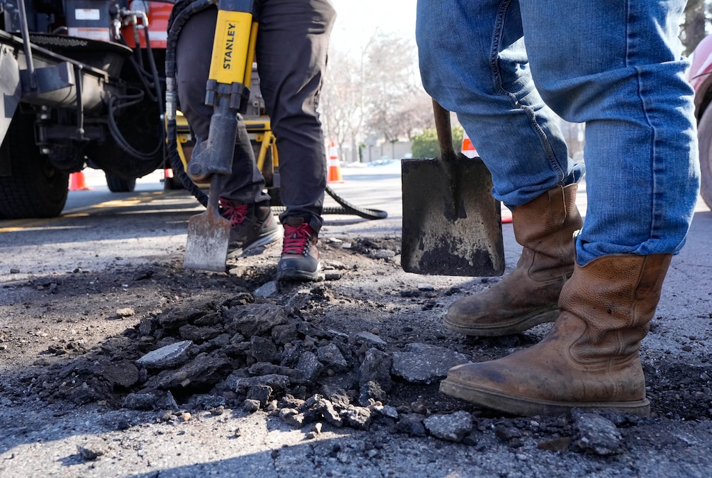 (Francisco Kjolseth | The Salt Lake Tribune) A prep crew with the Salt Lake City north district streets division work on filling potholes along North Star Drive near Redwood Road on Wednesday, Feb. 1, 2023.