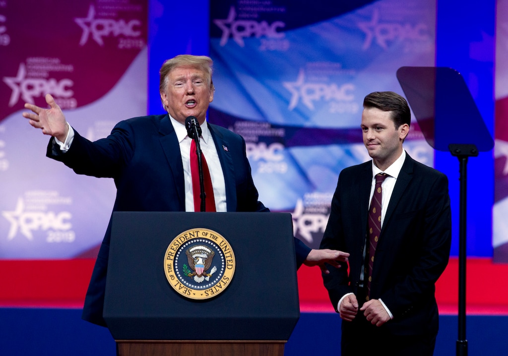 President Donald Trump invites to speak in the podium to Hayden Williams, a field representative of the Leadership Institute, who was assaulted at Berkeley campus speaks at Conservative Political Action Conference, CPAC 2019, in Oxon Hill, Md., Saturday, March 2, 2019. (AP Photo/Jose Luis Magana)