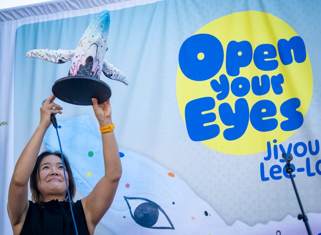 (Rick Egan | The Salt Lake Tribune) Salt Lake County artist Jiyoun Lee-Lodge holds up a model of her new design for the 9th and 9th whale, “Open Your Eyes,” which was unveiled during City Cast Salt Lake’s 801 Day celebration on Saturday, Aug. 1, 2026.