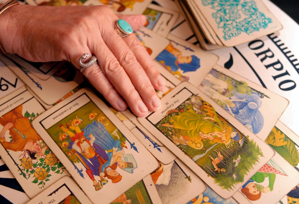 (Cheryl Gerber | AP) A psychic and tarot card reader reads a spread of tarot cards in 2007 in New Orleans. A new study shows young people in traditional faiths are also turning to divination.