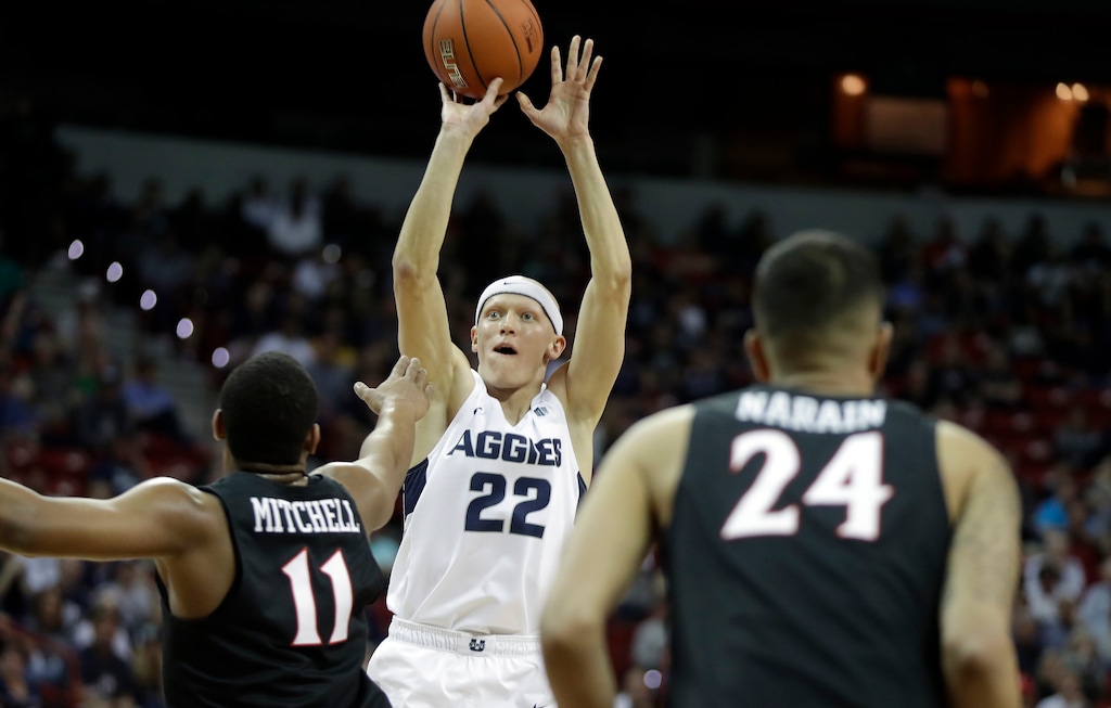 Utah State's Quinn Taylor shoots as San Diego State's Matt Mitchell (11) defends during the first half of an NCAA college basketball game in the Mountain West Conference men's tournament championship Saturday, March 16, 2019, in Las Vegas. (AP Photo/Isaac Brekken)