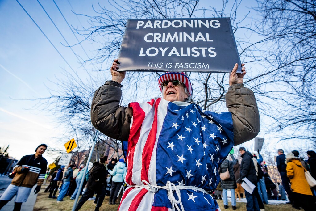 (Rick Egan | The Salt Lake Tribune) Tim Jeffryes holds a sign during a protest against federal immigration actions in Park City on Monday, Jan. 26, 2026.
