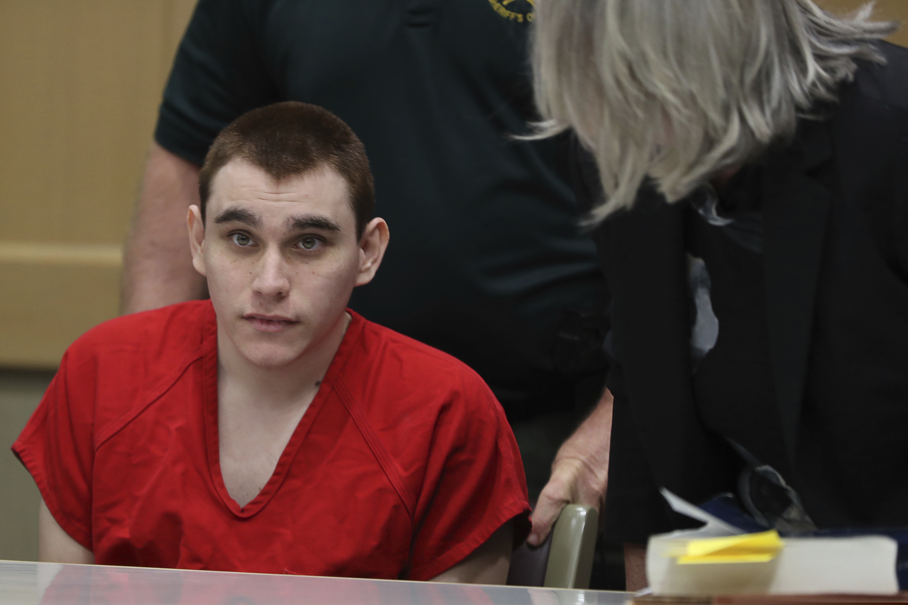 (Amy Beth Bennett | South Florida Sun-Sentinel via AP, Pool) Parkland school shooting suspect Nikolas Cruz sits down at the defense table for a hearing at the Broward Courthouse in Fort Lauderdale, Fla., Tuesday, Jan. 15, 2019. Cruz returned court this week for hearings on the Valentine's Day 2018 shooting at Marjory Stoneman Douglas High School in Parkland, Fla., and on accusations he assaulted a corrections officer.