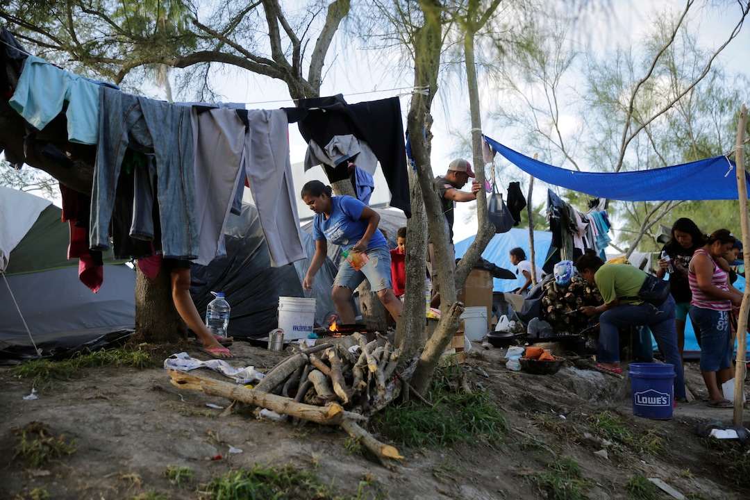 In this Tuesday, Nov. 5, 2019, photo, migrants live in a refugee camp in Matamoros, Mexico. The camp is an outgrowth of the Trump administration’s “Remain in Mexico” policy, in which more than 55,000 migrants have been told to wait and pursue their cases south of the border. (AP Photo/Eric Gay)