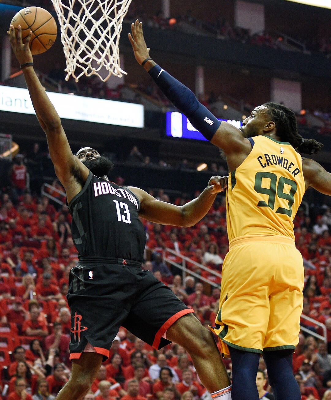 Houston Rockets guard James Harden (13) drives to the basket as Utah Jazz forward Jae Crowder defends during the first half in Game 1 of an NBA basketball second-round playoff series, Sunday, April 29, 2018, in Houston. (AP Photo/Eric Christian Smith)
