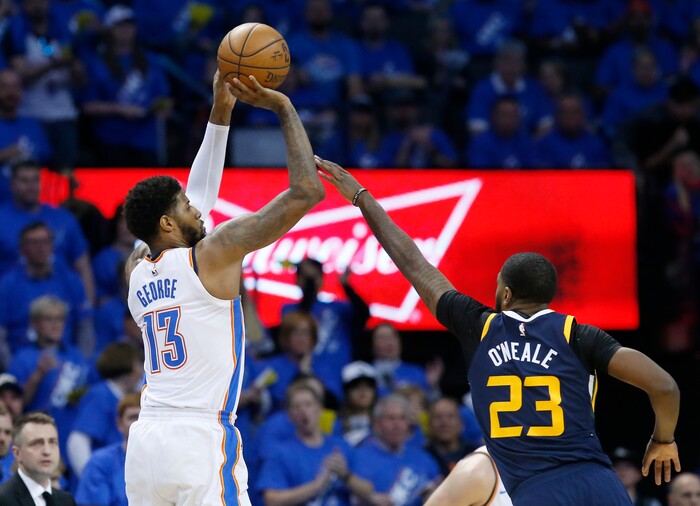 Oklahoma City Thunder forward Paul George (13) shoots in front of Utah Jazz forward Royce O'Neale (23) in the second half of Game 1 of an NBA basketball first-round playoff series in Oklahoma City, Sunday, April 15, 2018. (AP Photo/Sue Ogrocki)