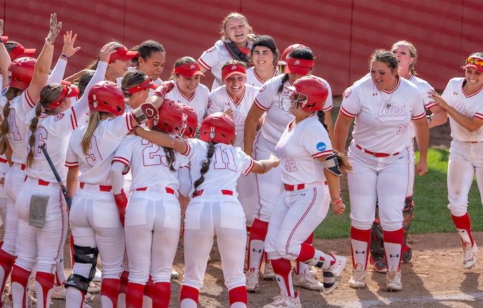 (Rick Egan | The Salt Lake Tribune)  The Utes greetJulia Jimenez as she crosses home plate, after hitting a grand slam home run, giving Utah a 7-1 lead, in NCAA Softball Super Regionals action between the Utah Utes and the San Diego State Aztecs, on Saturday, May 27, 2023.

