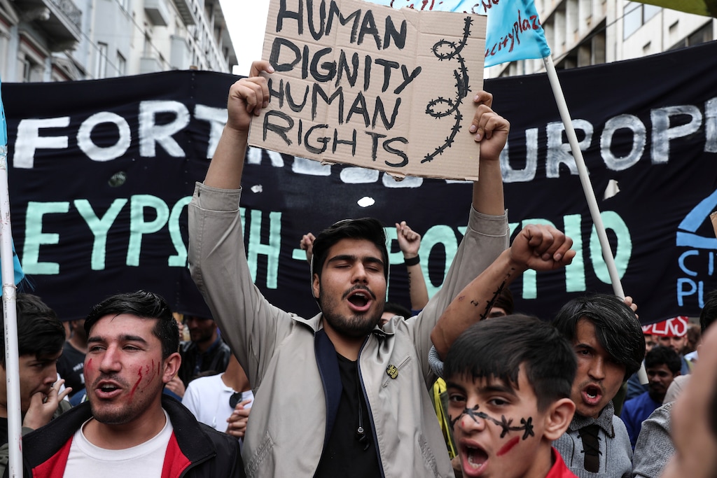 (AP Photo/Yorgos Karahalis) Migrants who live in Greece chant slogans during a rally against the EU-Turkey deal  blocking mass migration into Europe, in Athens, Saturday, March 17, 2018.