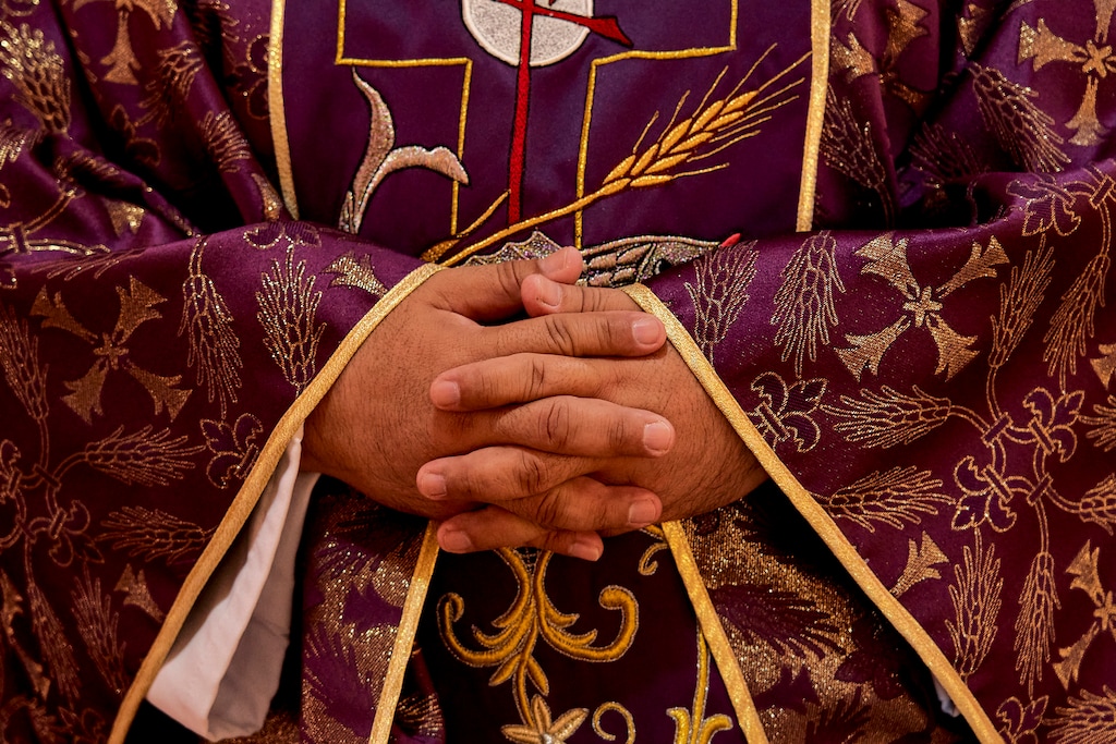 (Philip Cheung | The New York Times)

A detail of the Rev. Jesus Zamarripa's hands at Our Lady of Lourdes Catholic Church in East Los Angeles, Feb. 27, 2021. "With a churchgoing Democrat in the White House, faith becomes more complicated in America. Thank God," writes New York Times opinion columnist Nicholas Kristof.