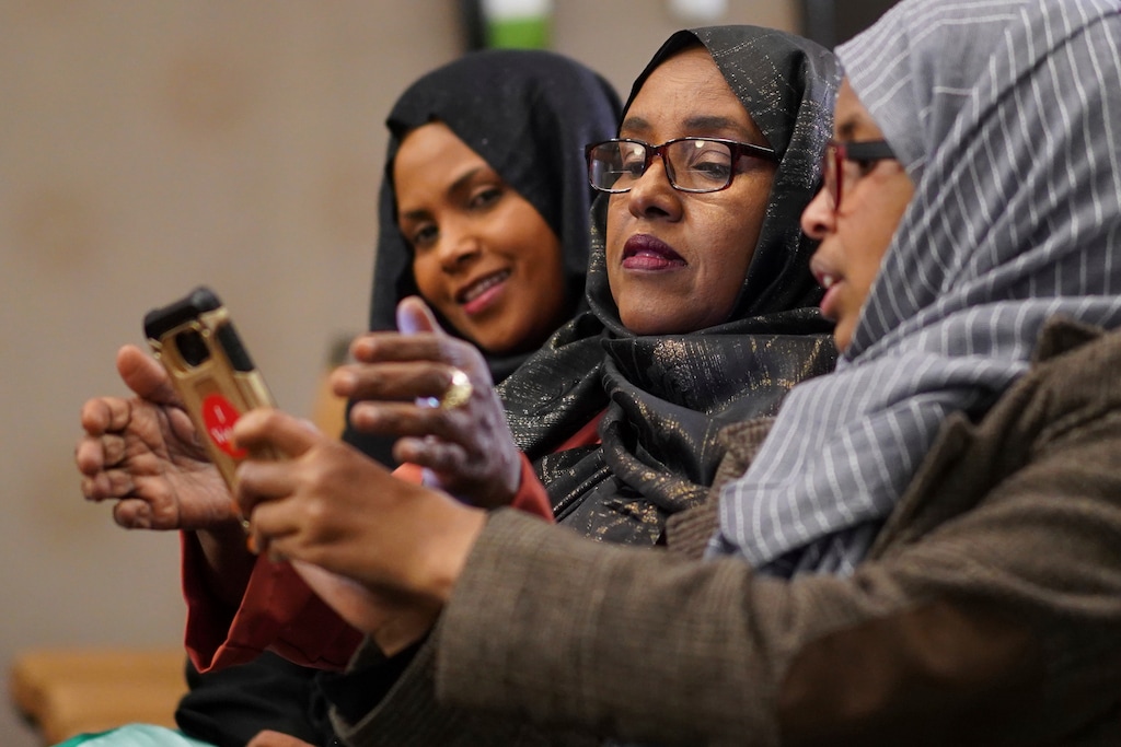 Hibo Omar, Muhubo Shire and Kin Kyani watch results at Democratic congressional candidate Ilhan Omar's election night headquarters in Minneapolis on Tuesday, Nov. 6, 2018. State Rep. Ilhan Omar has won Minnesota's 5th District race to become the first Somali-American and one of the first Muslim women elected to Congress. (Mark Vancleave/Star Tribune via AP)