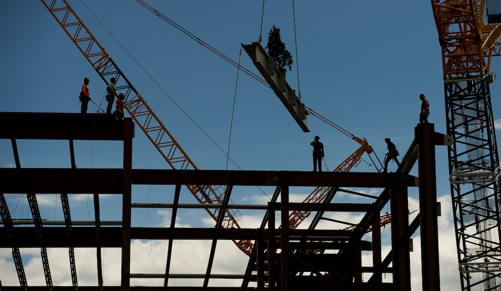 (Leah Hogsten  |  Tribune file photo) Iron Workers position the last steel beam during a "topping out" ceremony at the new Salt Lake City International terminal building on May 22, 2018.