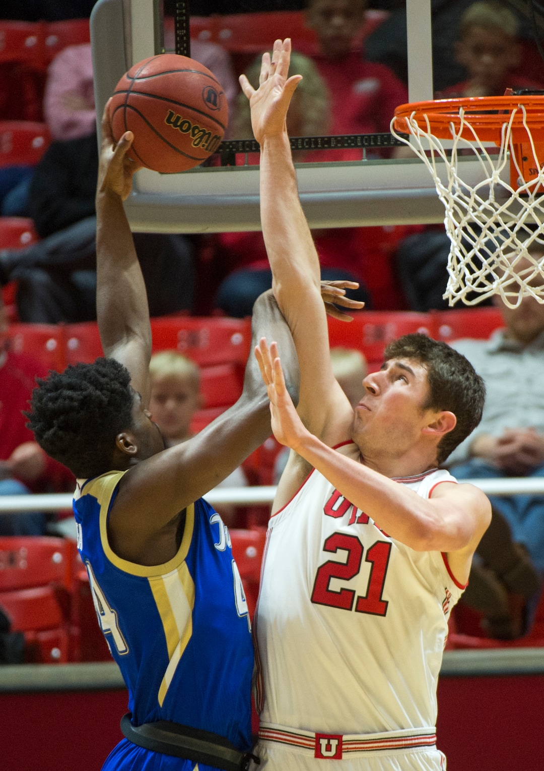 (Rick Egan  |  The Salt Lake Tribune)    Tulsa Golden Hurricane forward Simon Falokun (44) shoots overUtah Utes forward Riley Battin (21), in basketball action between, Utah Utes and Tulsa Golden Hurricane, at the Jon M. Huntsman Center, Saturday, Dec. 1, 2018.