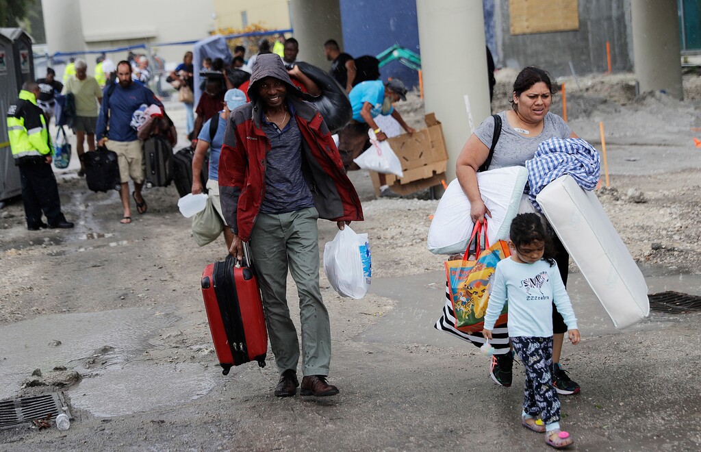 (AP Photo/David Goldman) Evacuees are moved to another building with more bathrooms while sheltering at Florida International University ahead of Hurricane Irma in Miami, Saturday, Sept. 9, 2017.