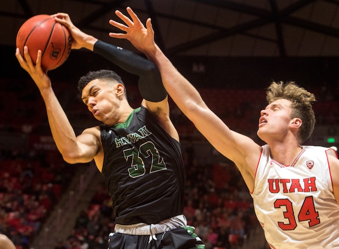 (Rick Egan  |  The Salt Lake Tribune)  Utah Utes forward Jayce Johnson (34) goes for a rebound along with Hawaii Warriors guard Samuta Avea (32), in basketball action, Utah Utes vs Hawaii Warriors, at the Jon M. Huntsman Center, Saturday, December 2, 2017.