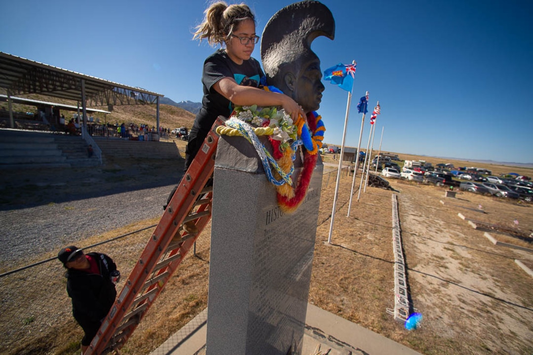 (Trent Nelson | The Salt Lake Tribune)  Descendants of the Hawaiians who settled the desert town of Iosepa took time during their Memorial Day gathering to clean the graves of their ancestors, Saturday May 26, 2018.  Lina Ahquin puts a lei onto a historical monument.