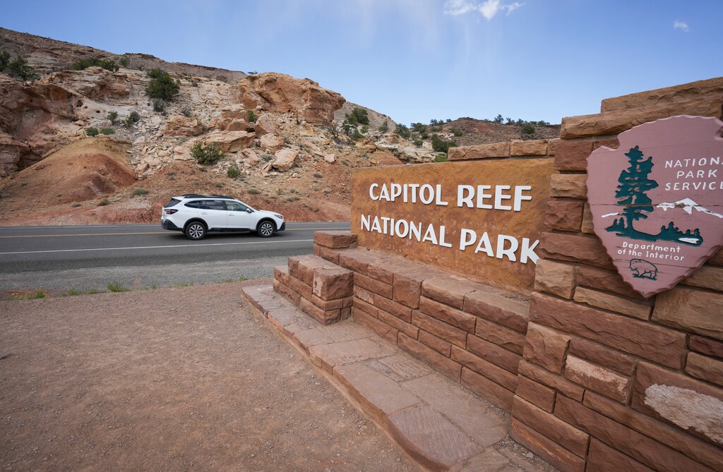 (Bethany Baker  |  The Salt Lake Tribune) A car drives past the sign for Capitol Reef National Park near Torrey on Saturday, June 7, 2025.