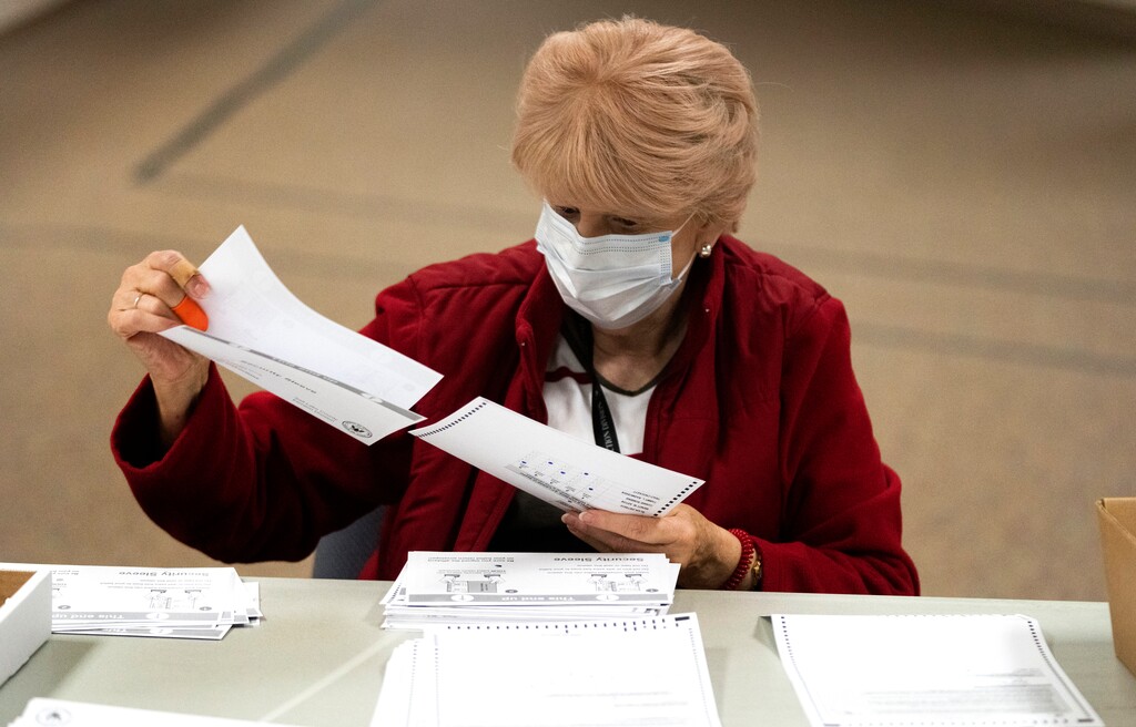 (Rick Egan | The Salt Lake Tribune) Susan Janes sorts ballots at the Salt Lake County Government Center on Wednesday, Oct. 27, 2021.